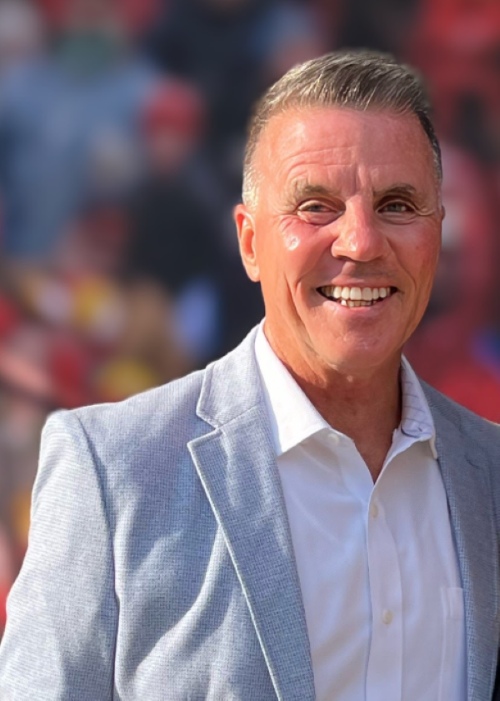 Mike Law, caucasian male, 50ish with short blonde/gray hair, dressed in collared shirt and jacket, smiling